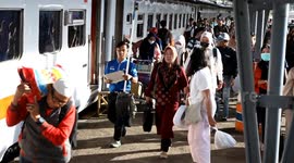 Passengers arrive at Kertapati train station in Palembang, Indonesia to celebrate Eid al-Fitr in their hometown on March 22, 2025. The mass exodus out of the capital and other major cities in the world's most populous Muslim country is underway as million