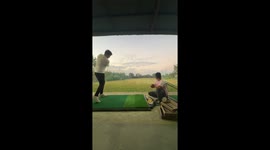 Golf player whacks ball against roof... leaving his coach in fear