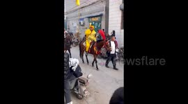 Startled horse sends rider flying and knocking spectators to ground during ceremony in China