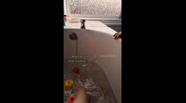 Mischievous toddler throws everything into the tub during mom's bathtime