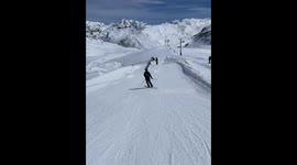 Skier Recovers From Backward Tumble