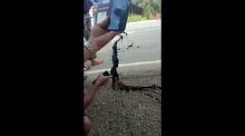 Road collapses into water as people cheer in Jambi, Indonesia
