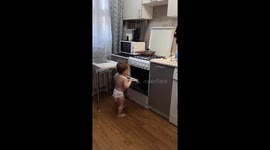 Toddler uses oven to climb onto high chair in Vladimir, Russia