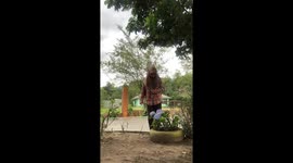 Woman pricked by plant stem while inspecting flower in Aceh, Indonesia
