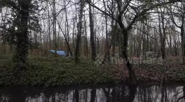 In the winter of January, people live in makeshift tents in the Bois de Vincennes nature reserve in Paris. The tent cities are equipped with washbasins, tables, and dishware, highlighting a unique aspect of life in the park.