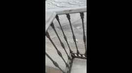 Water mixed with hail streams down roads in Malaga