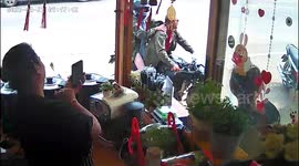 Embarrassed couple topple over while trying to ride away on motorbike