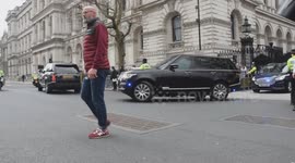 Police apprehend elderly woman as protesters gather outside Downing Street as budget is announced