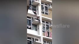 Two boys seen sitting on apartment block balcony in Hong Kong