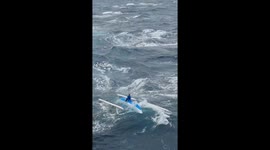 Sailor found sitting on capsized boat in rough sea in Indonesia