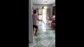 Housewife chases away snake slithering through her home