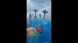 Family creates splashing memories on an inflatable balloon at the resort