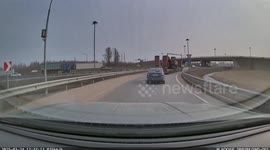 Fast-moving car swipes crash barrier and rams truck before spinning out of control