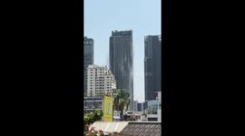 Roof top swimming pool spills over building during Bangkok earthquake