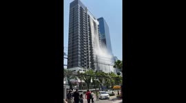 Roof top swimming pool cascades over apartment block during earthquake