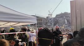 Firemen search wreckage of collapsed building in Bangkok earthquake