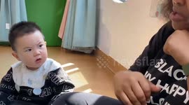 Child maintains serious expression while listening to children's song in Fujian, China