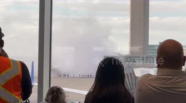 Smoke Billows From Grounded Airplane