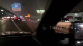 US: Floodwaters Trap Cars on Texas Interstate