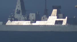 HMS Dragon Royal Navy Frigate on sea trial off the Cornish Coast, intrigues beachgoers. Cornwall UK