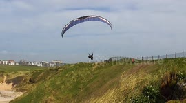 UK Weather, April arrives this week and it looks set to bring a burst of spring warmth. Paragliders on the coast, Cornwall, UK
