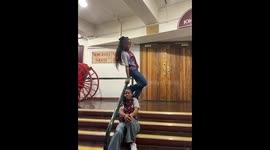 Woman loses balance while sitting on stair handrail in Johannesburg, South Africa