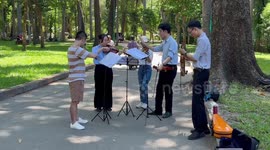 Wholesome scene as pupils have band violin practice in the park