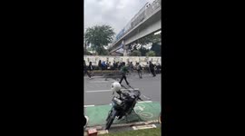 Protesters attack armed officer during unrest in Indonesia