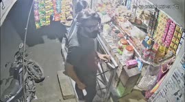 Rampaging stray cow knocks over motorcycle rider outside shop