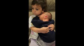 Toddler Protective While Cuddling With Baby Brother