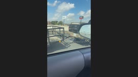 Driver Straps Trailer Securely To Truck