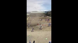 Dust devil tornado tears through school field during marching band practice