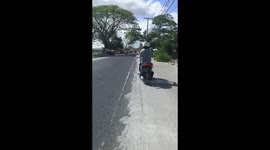 Motorcycle with wonky wheel rides along road