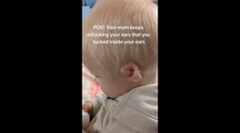 Untucking a child's ear that has been tucked inside itself