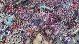China: People dancing to celebrate the SANYUESAN festival at the Wangmu Cultural Square