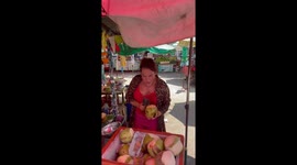 Food vendor enthusiastically chops coconuts in Thailand