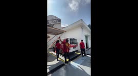 Worker does pull ups and rests on friend's head
