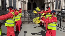 UK: Activists dressed as airplane marshallers stage a protest against airport expansions outside the Royal Courts of Justice