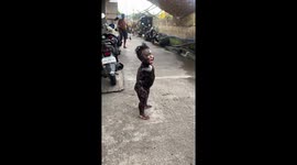 Child dressed in unique black oil costume for Halloween in Manila, Philippines