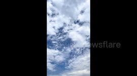Parachuter performs daring high-speed landing as he skids along ground into hangar