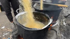 Displaced Palestinians receive hot meals as food shortages worsen in Gaza
