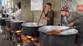 Displaced Palestinians in Nuseirat camp queue for hot meals as Israeli genocide continues unabated