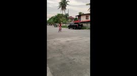 Girls tumbles from pink bike while trying to learn cycling trick