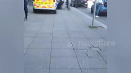 Shocking moment 'armed man' lay in street after being shot by police