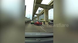 Kind motorcycle rider rescues kitten scampering along busy motorway