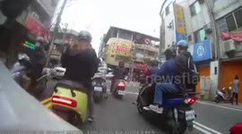 Motorcycle rider dodges truck carrying metal pipes