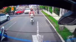 Distracted motorcycle rider crashes into back of car while changing lanes