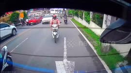 Distracted motorcycle rider crashes into back of car while changing lanes
