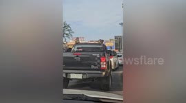 Wild monkeys climb over pickup truck in Thai town