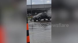 Car's wheels keep spinning without vehicle moving during rain